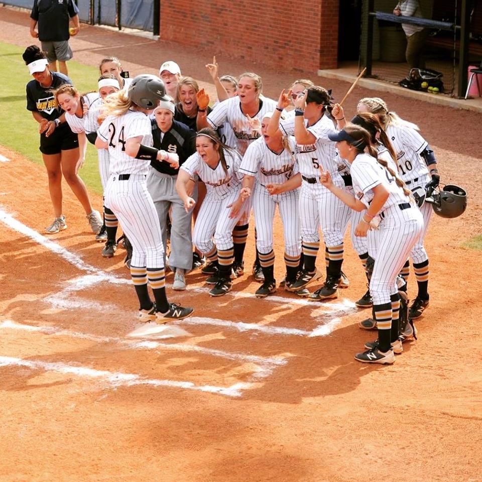 a softball team celebrating