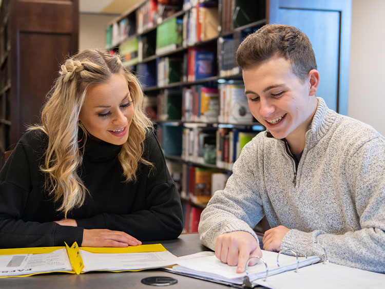 Two students in library studying